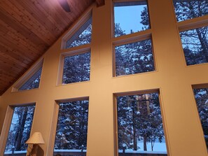 Enjoy serene views of the surrounding forest from the room's multiple windows.