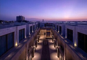 Enjoy the city skyline views from our rooftop terrace, featuring a central pathway and seating area.