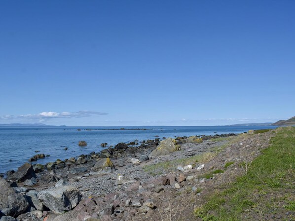 A rocky shoreline with a clear view of the sea and distant land. - 2 bedroom accommodation in Lendalfoot, near Girvan (Lendalfoot, near Girvan)