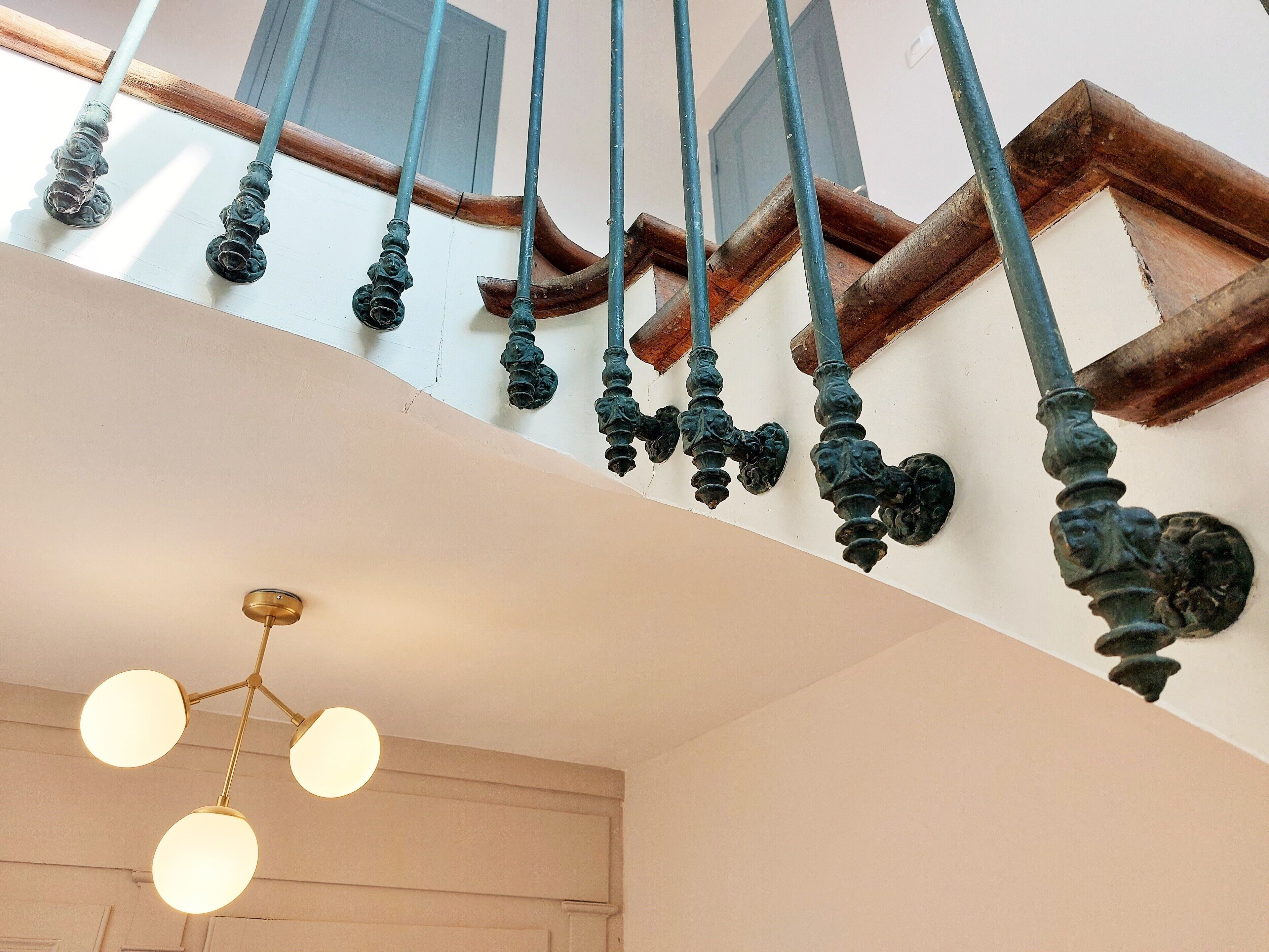 Un escalier orné de balustres noirs et doté d’une main courante en bois.