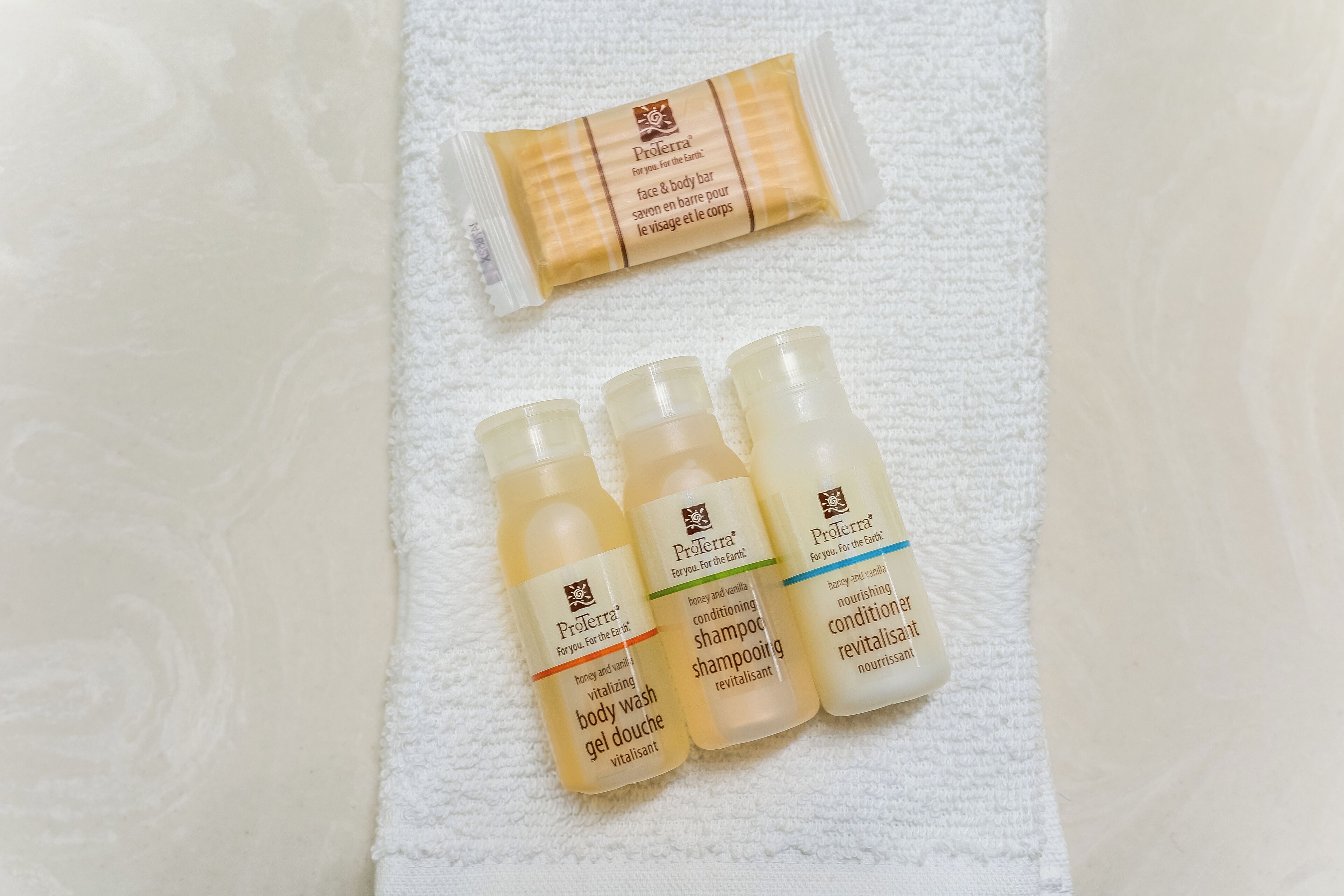 A Proterra body wash and shampoo set on a white towel.