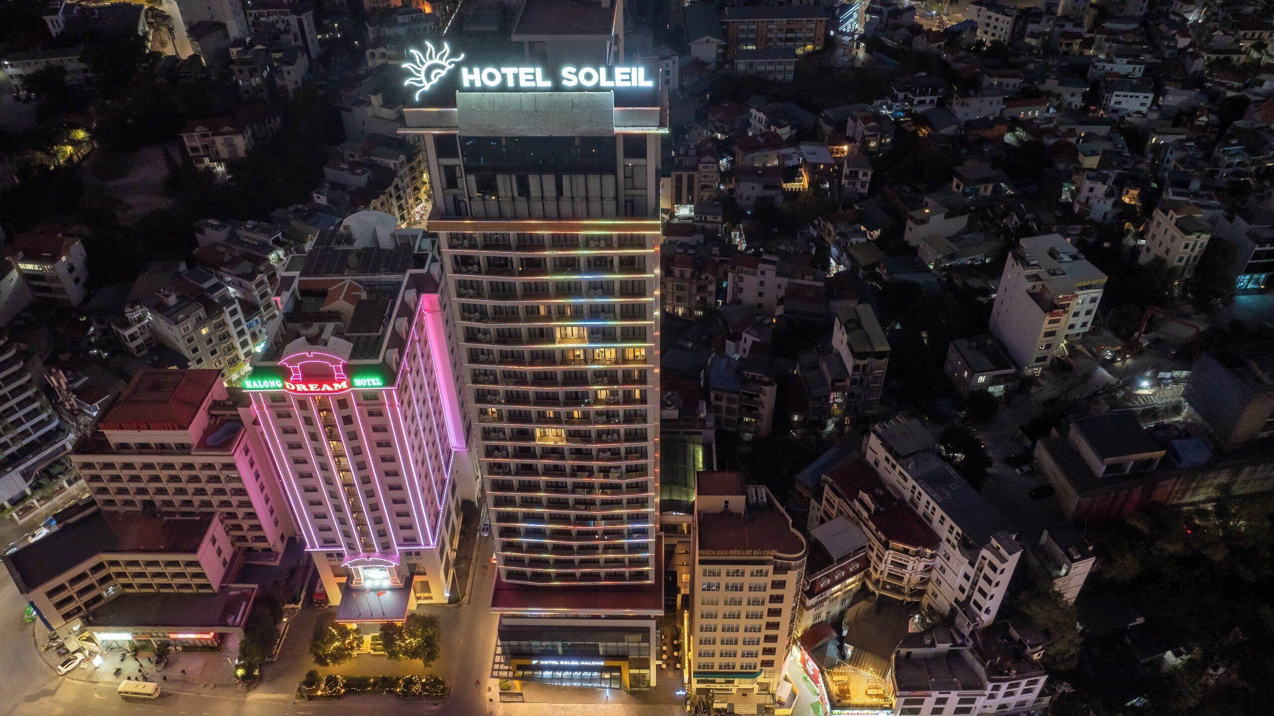A high-rise hotel with multiple floors, prominent signage, and a well-lit facade.