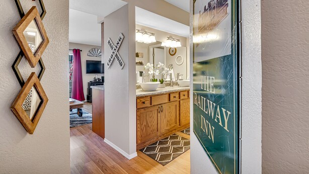 A modern kitchen with wooden cabinets, a white countertop, and a large island. - Freshly Remodeled Condo - Fall Creek Resort (Branson)