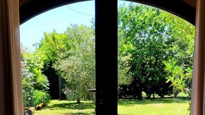 A double door with a view of a well-maintained garden. - 3 Bedroom Private vacation home in PINSAC (PINSAC)