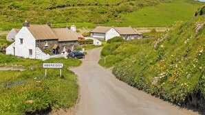 A rural road leading to a village with stone houses, a sign reading 'ABERREIDRY,' and a car parked by the roadside. - 4 bedroom accommodation in Llanhrian, nr Haverfordwest (Llanhrian, nr Haverfordwest)