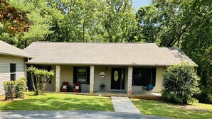 A two-story house with a covered porch, a front door, and a small front yard. - Family friendly lake front home with private dock in a cove (Winchester)