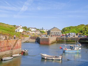 A harbor with boats, a lock, and houses in the background.