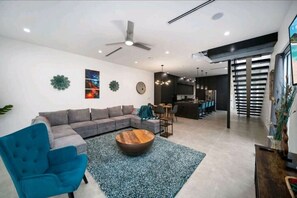 Relax in this stylish living space with a sofa, coffee table, and armchair, perfect for unwinding.