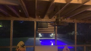 A room with a pool, a large American flag, and two surfboards. - Perfect Hamptons Family Fall escape (Hampton Bays)
