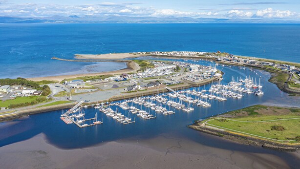An aerial view of a marina with numerous boats docked, surrounded by water and land. - 2 bedroom accommodation in Pwlheli (Pwlheli)