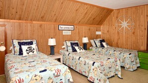 A room with wooden walls, two beds with nautical-themed bedding, a sign indicating the room is for sleeping with one open window, and a compass on the wall. - Walk Everywhere! Pet Friendly Rehoboth Beach Home Sleeps 10 (Rehoboth Beach)