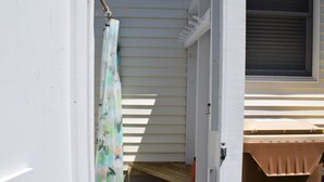 A narrow entryway with a wooden bench and a window with blinds. - Walk Everywhere! Pet Friendly Rehoboth Beach Home Sleeps 10 (Rehoboth Beach)