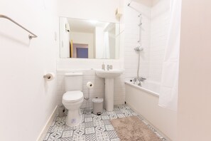 Bathtub, towels, toilet paper