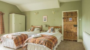 A bedroom with two beds, a wardrobe, and a door with a sign. - Lower House B&B (Craven Arms)