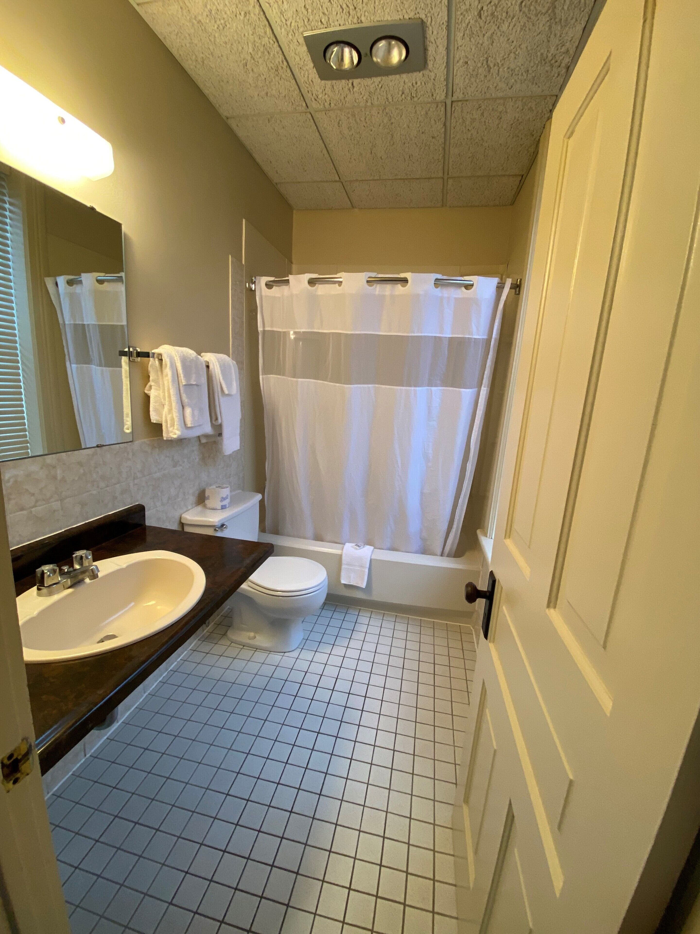 basic queen with sofa | bathroom | hair dryer, towels, soap, shampoo