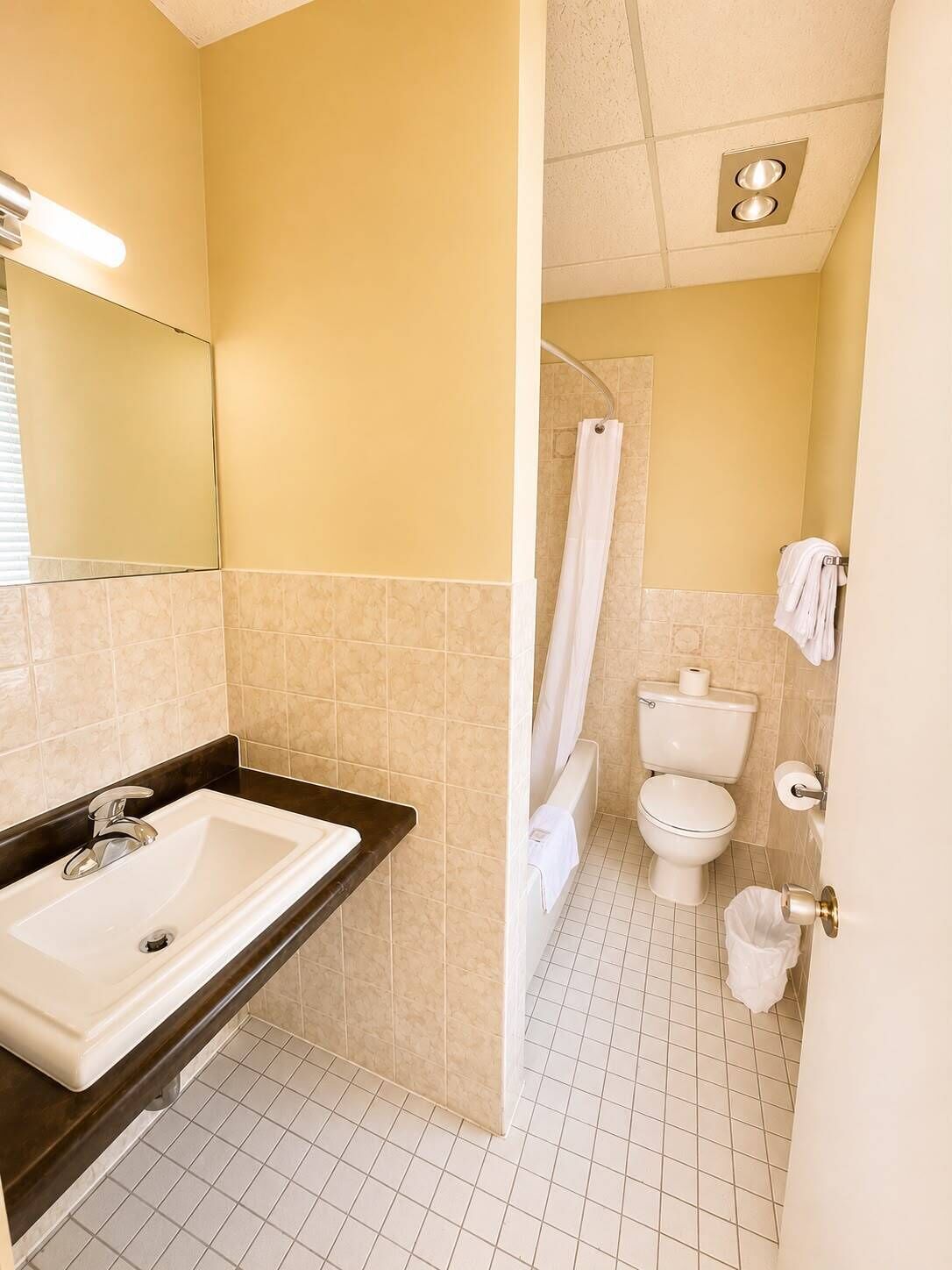 A bathroom with a sink, toilet, and shower.