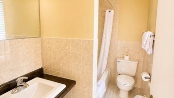 A bathroom with a sink, toilet, and shower.