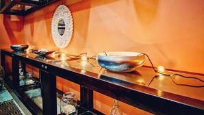 A kitchen with a wooden countertop, a decorative mirror, and a hanging light fixture. - Super spacious (Quatre Bornes)