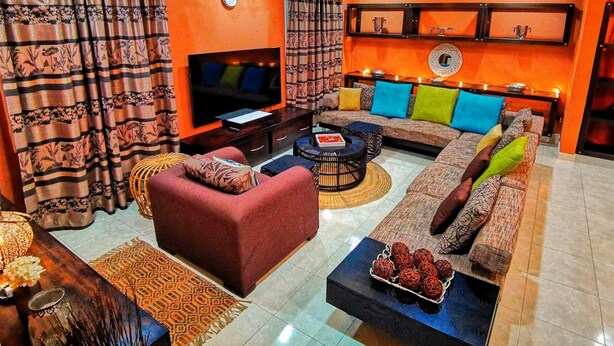 A living room with a sofa set, a television, and a coffee table. - Super spacious (Quatre Bornes)