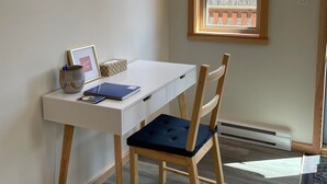 A study area with a desk, chairs, a window, and a pendant light. - Private mountain view haven in the beautiful West Kootenays (Kaslo)