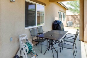 Enjoy al fresco dining and relaxation in this outdoor patio, complete with a grill and comfortable seating for six.