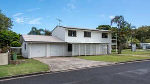 A two-story house with a garage, a driveway, and a lawn.