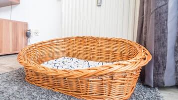 A wicker basket on a gray carpet.