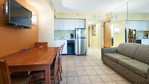 A compact living space with a dining area, kitchenette, and a sofa. - Ocean Sands Resort Oceanfront condo with Oceanfront Balcony! (Virginia Beach)