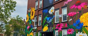 A building with colorful floral murals on its facade.