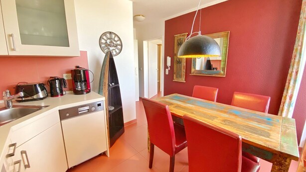 A compact kitchen with white cabinets, a coffee maker, and a clock on the wall. - Apartment 307 - Rondell an der Jasmundtherme - Neddesitz an der Jasmundperle / (Sagard)