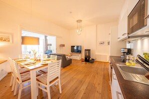 A modern kitchen with a microwave, stove, and sink.