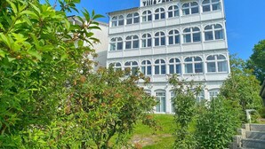 A multi-story building with a classic architectural style, featuring arched windows and a prominent entrance. - Sea view apartment no. 21 in the Villa Anna in Sassnitz on Rügen - Sassnitz - (Sassnitz)