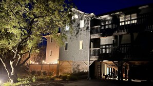 A multi-story building with a brick facade and a balcony. - Oceanside DUCK Beach Home, 5 minute walk to Beach & Shops (Duck)