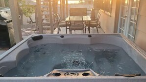 A hot tub with a table and chairs in a covered outdoor area. - Lake view, Pool, 2 miles to Bridge, 12 ppl (Lake Havasu City)