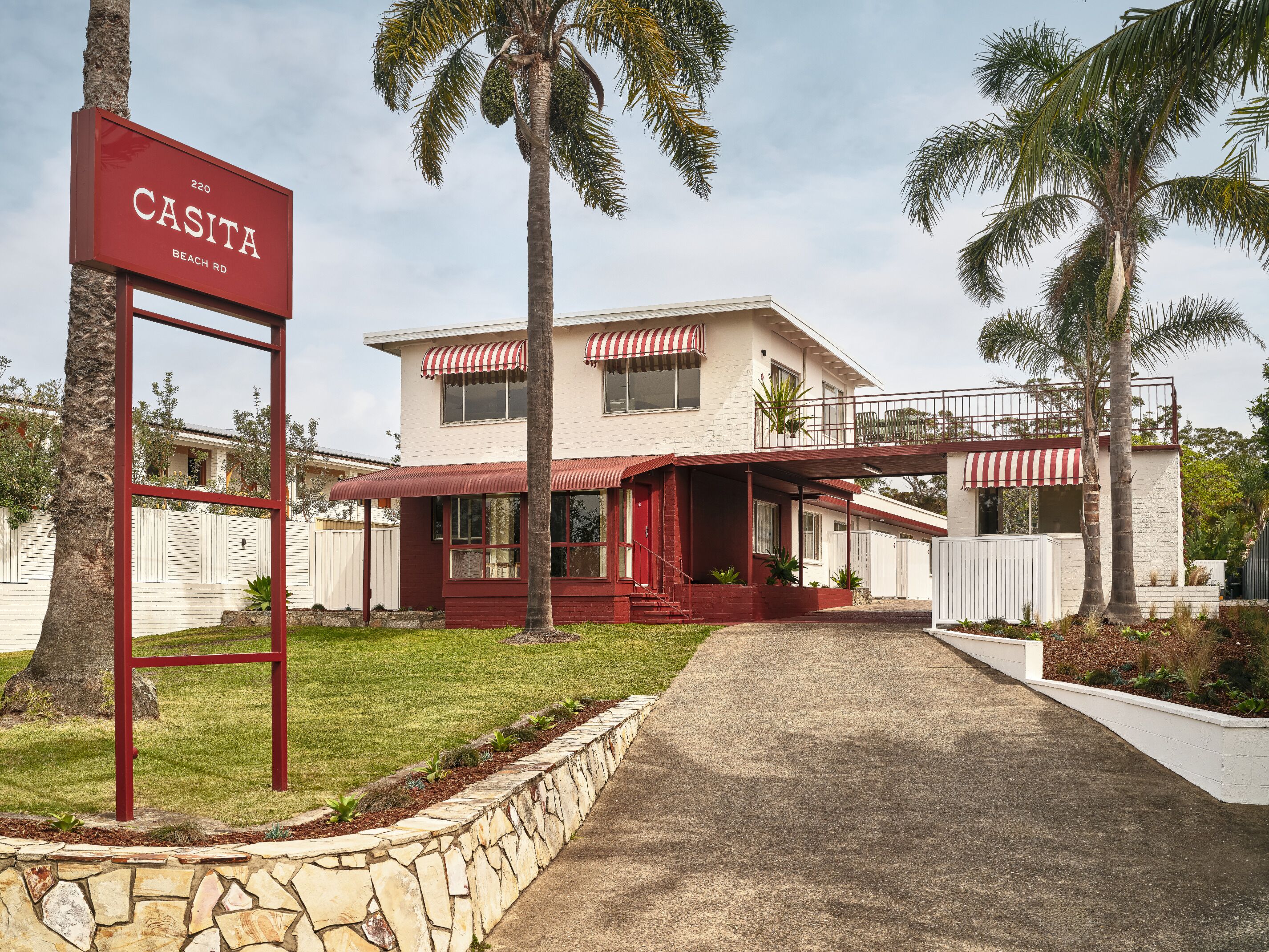 A two-story building with a red and white sign reading "CASITA BEACH RD."