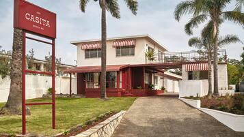 A two-story building with a red and white sign reading "CASITA BEACH RD."