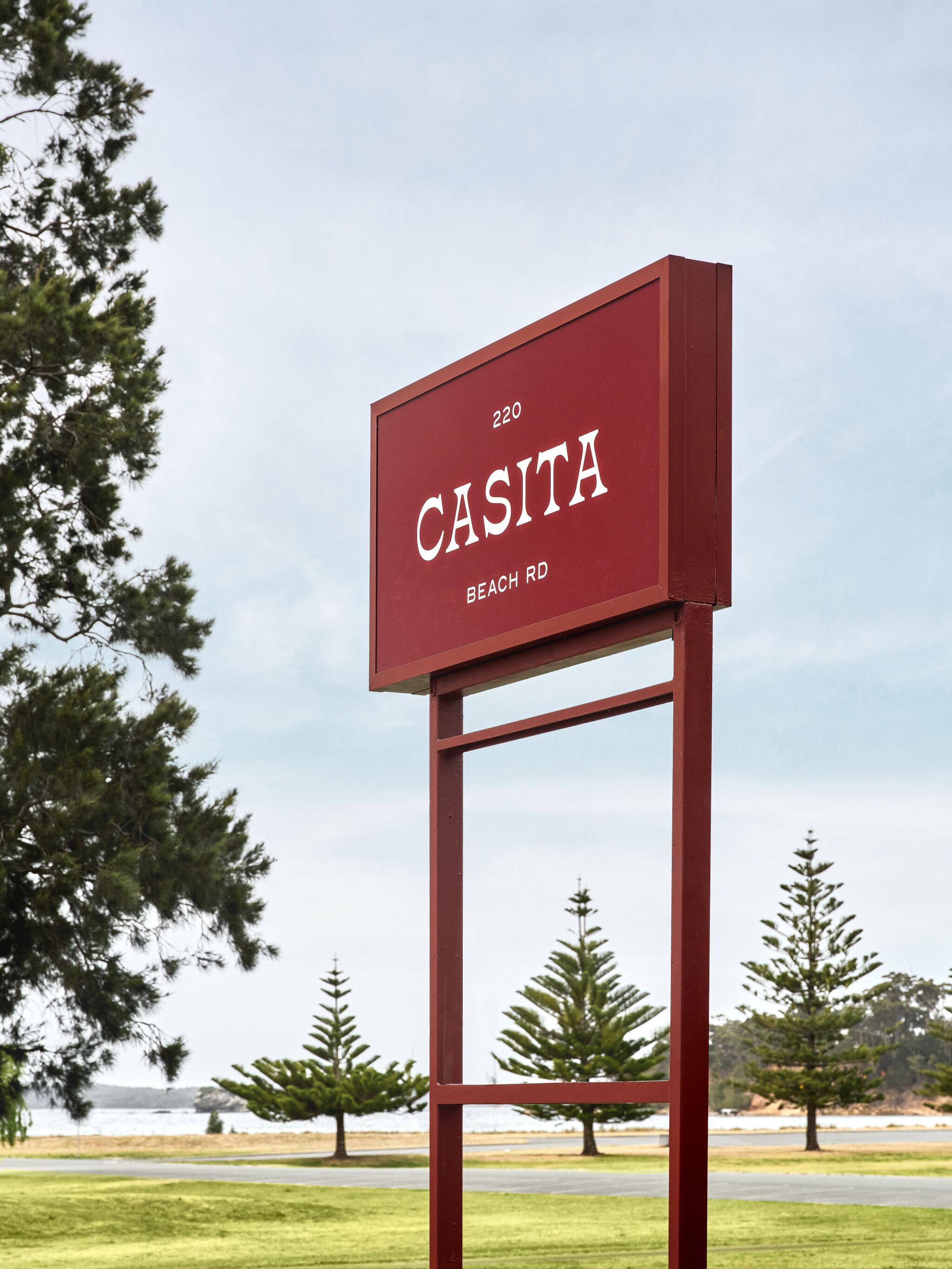 A red sign with the text "CASITA BEACH RD 220".