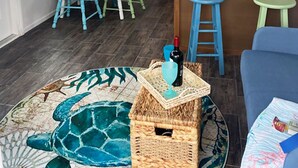 A compact living space with a dining area, kitchen, and a small seating area.