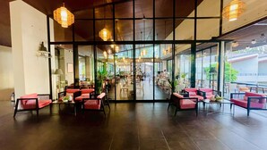 A spacious indoor dining area with modern furnishings and large windows. - TASALA cabana (Tha Sala)