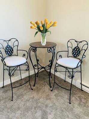 Two comfortable chairs and a small table create a cozy seating area.
