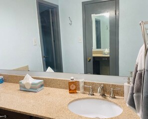Bathtub, towels, soap, shampoo