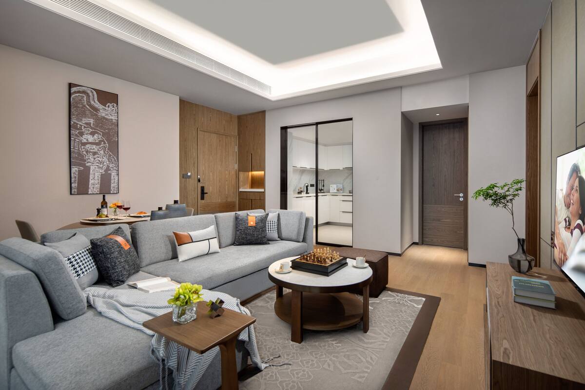 A modern living room with a sofa, coffee table, and a chessboard.
