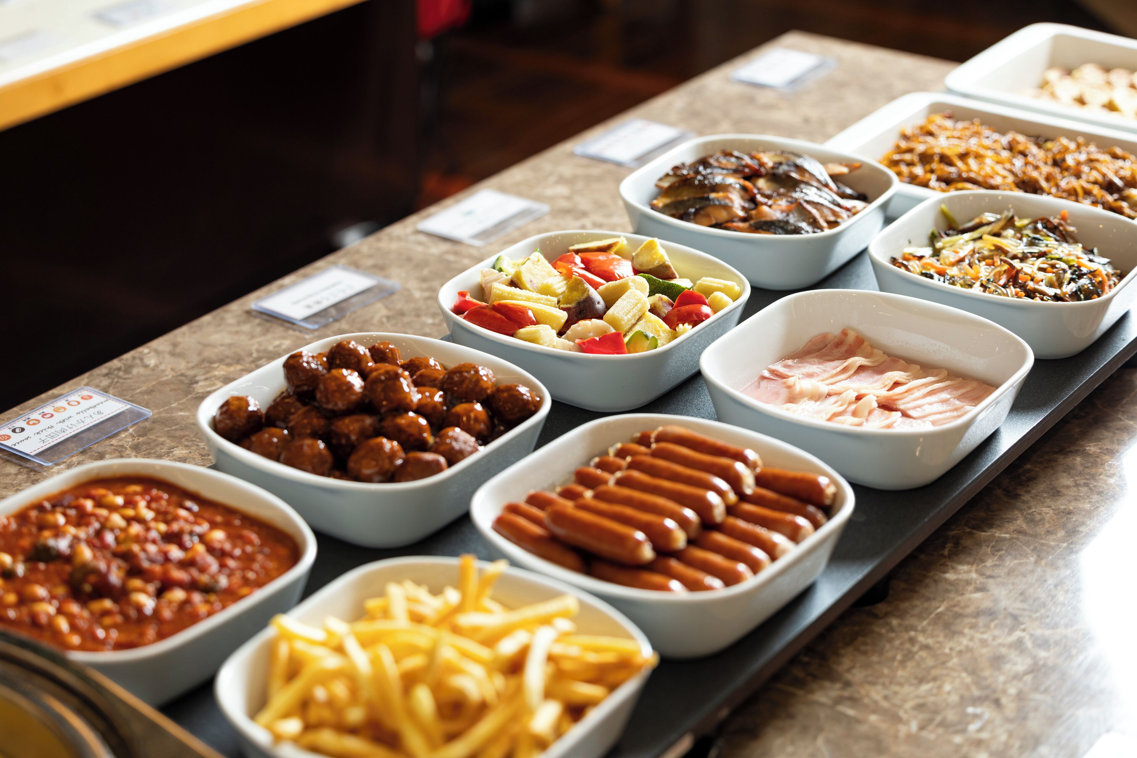 A buffet table with various food items.