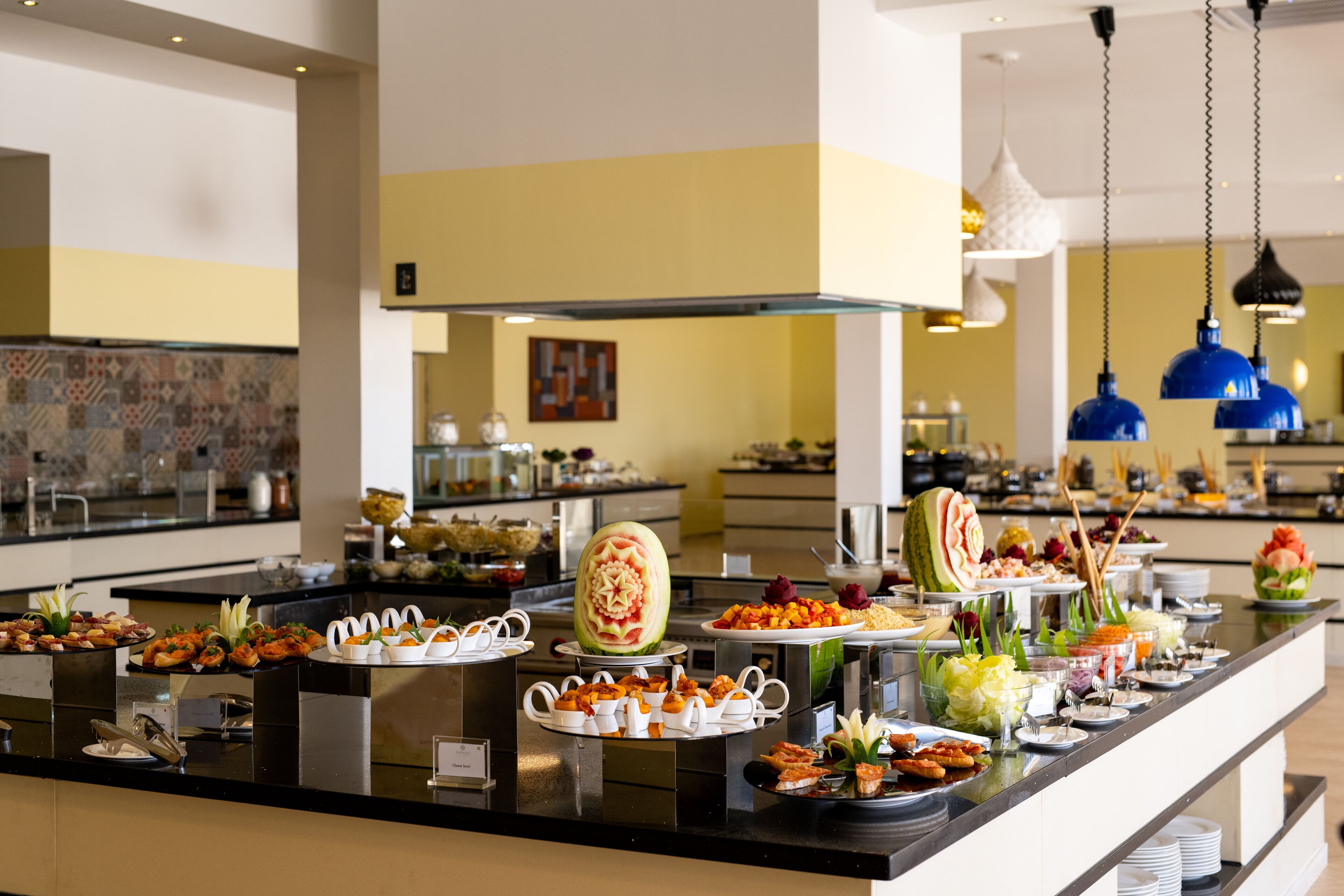 A buffet with various food items and a decorative centerpiece.