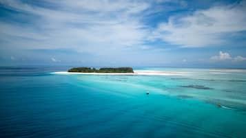 A tropical island with clear turquoise waters and a sandy beach.