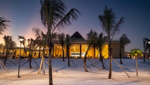 A resort with a large building, palm trees, and a sandy area. - The Mora Zanzibar - Luxury All Inclusive (Matemwe)