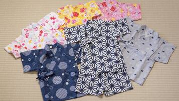 Diverse kinderkleding uitgestald op een oppervlak met structuur.