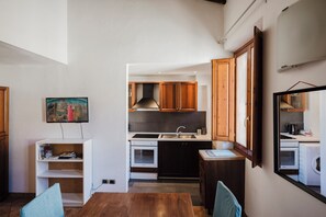 A compact kitchen with a sink, stove, and cabinets. - Condotta - Two Bedroom Apartment, Sleeps 3 (Firenze)