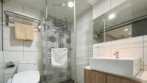 A modern bathroom with a glass-enclosed shower, a white toilet, and a wooden vanity with a sink. - Formosa101 Taipei Main Branch (Taipei)