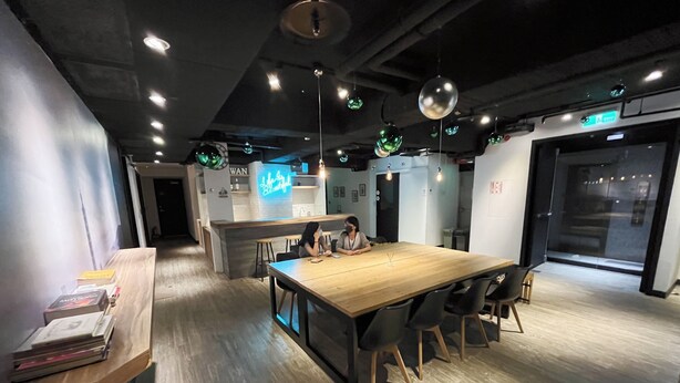 A modern meeting room with a wooden table, black chairs, and pendant lighting. - Formosa101 Taipei Main Branch (Taipei)
